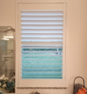 White window shutters with view of grass.