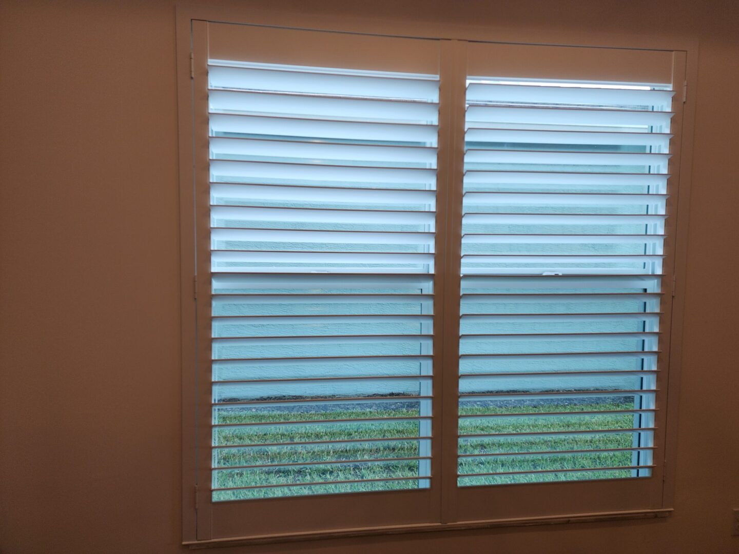 20240702_165701 White window shutters with green view.