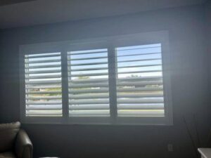 A room with blinds open and closed